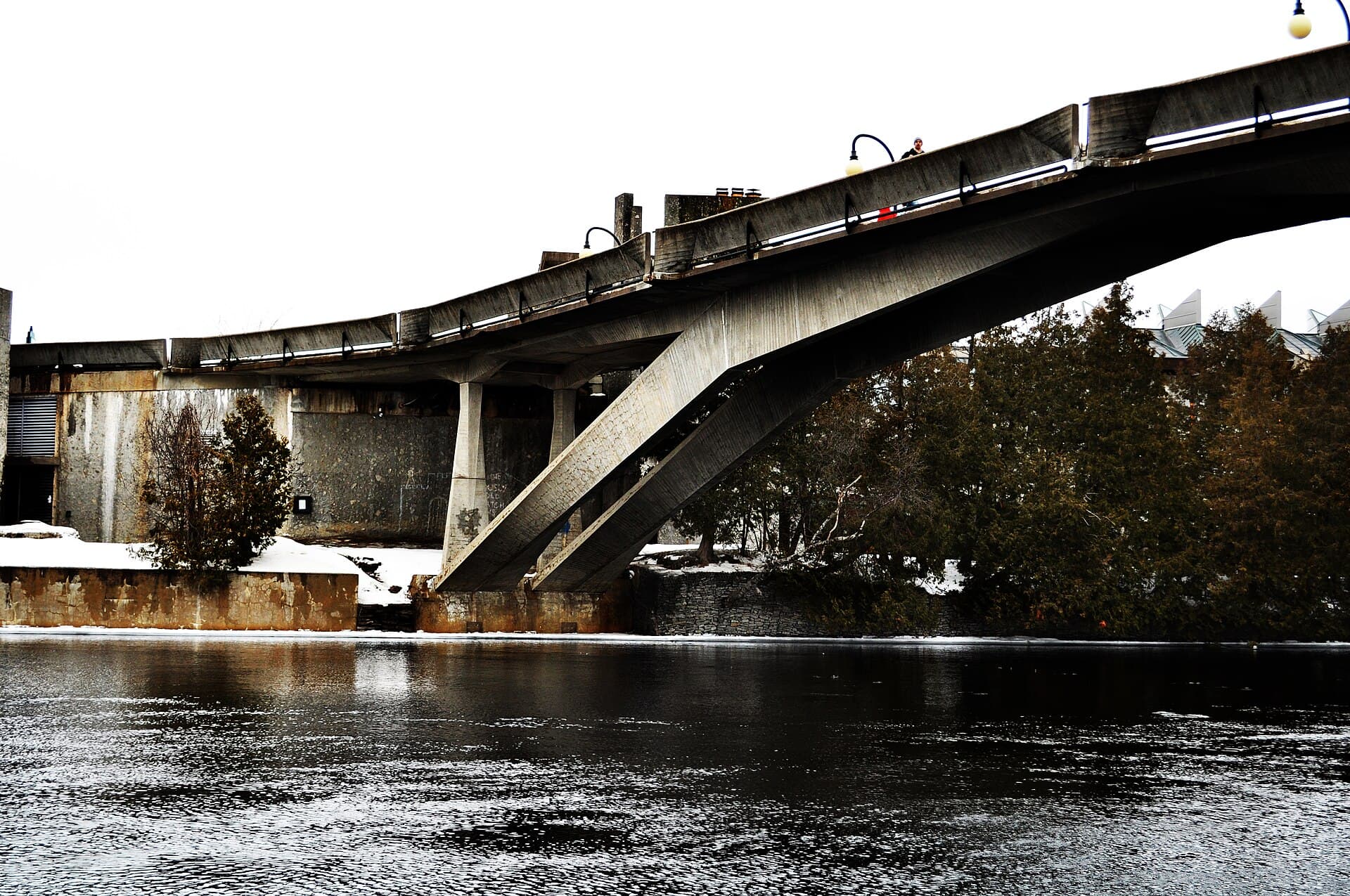 The Faryon Bridge at Trent University, a concrete footbridge crossing the Otonabee River in winter.