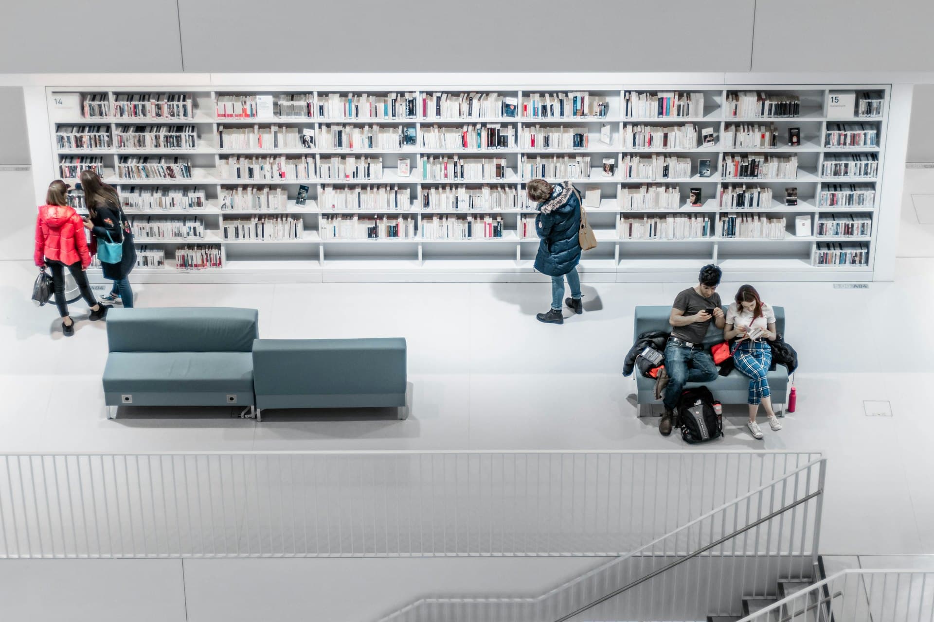 Students in a bright modern library seen from above